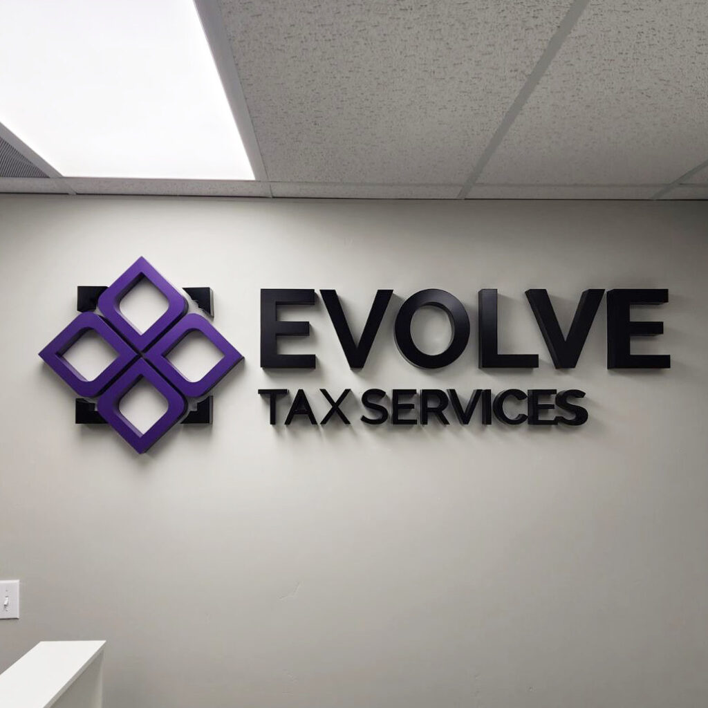 An example of painted dimensional letters in purple and black for Evolve Tax Services.