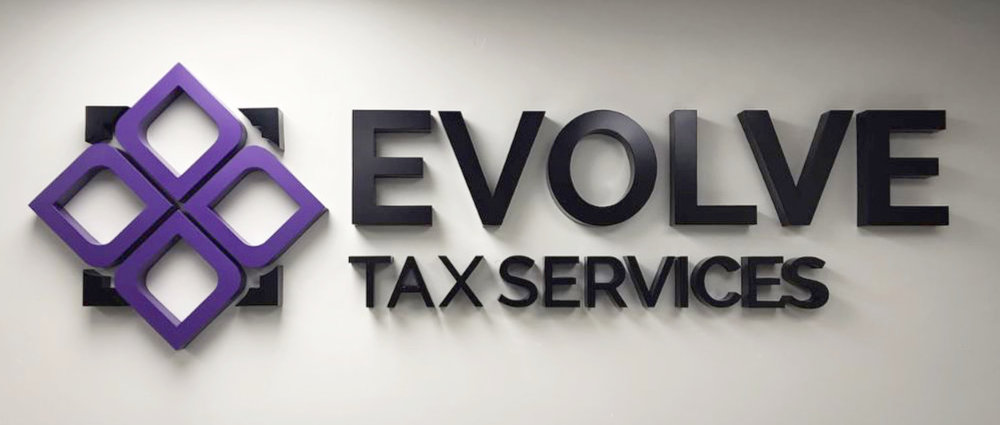An example of an interior acrylic letter sign with no lighting. Black and purple logo for Evolve Tax Services.