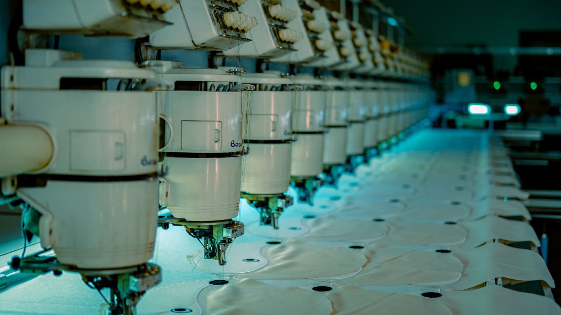 An embroidery machine decorates items.